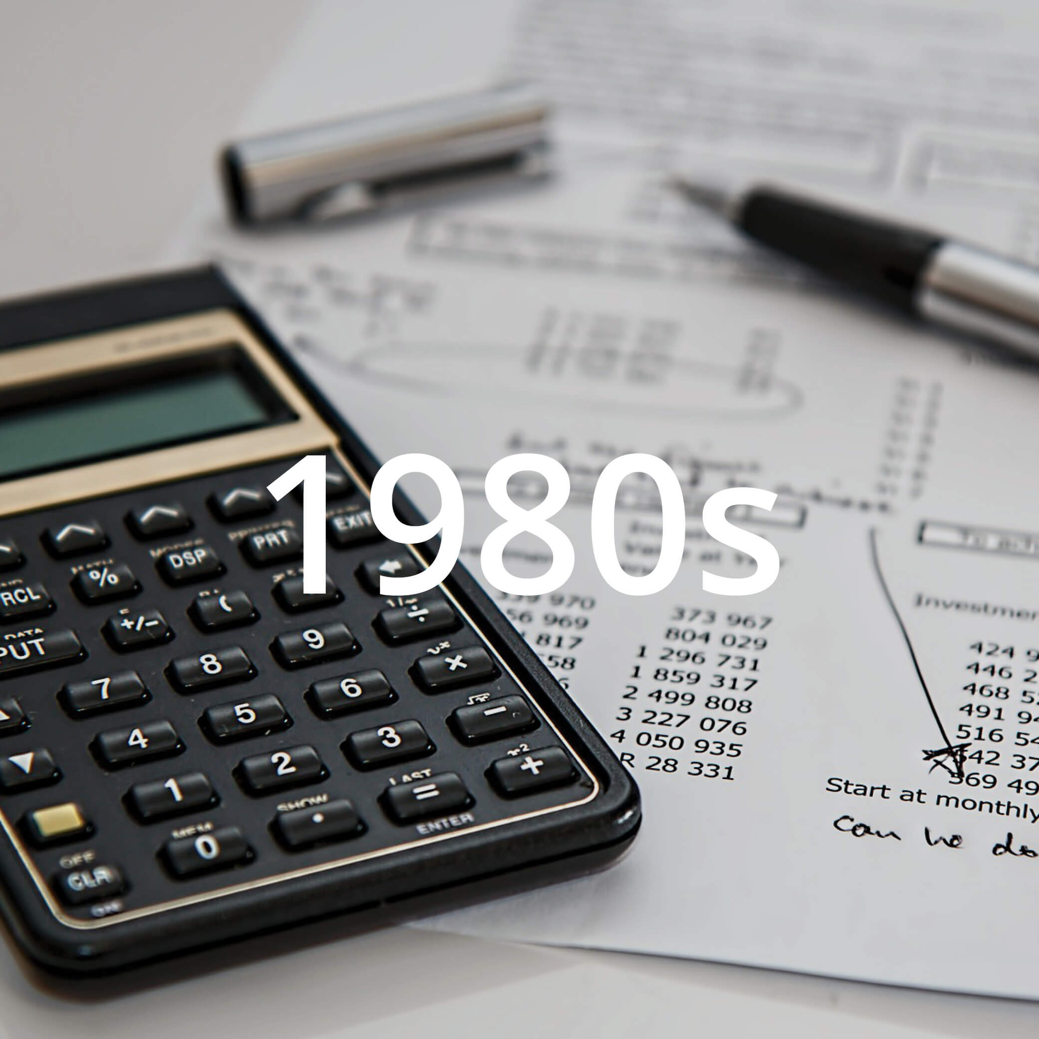 Photo of a calculator and pen and paper featuring financial information. Photo features text overlay that reads "1980s".